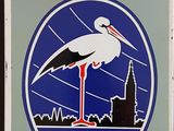 a picture of a sign with a clock and a picture of a stork