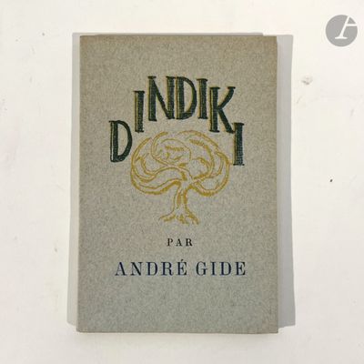 an old book sitting on top of a table next to a white wall