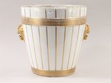 a white and gold vase with a lion head on it