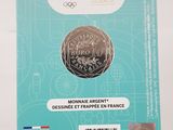 the front of a box with a coin on it sitting on a table
