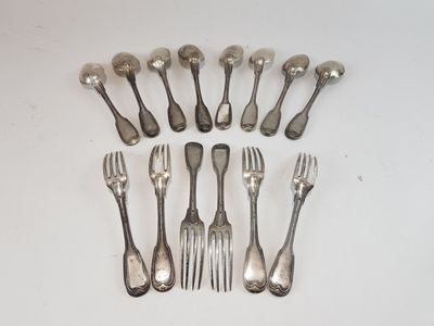 a lot of forks and spoons that are on the table