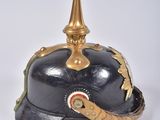 an old helmet with a gold spike on top of it