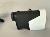 two black and white binoculars sitting next to each other on a table