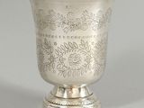 a silver cup that is sitting on a table