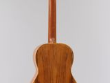 a close up of a wooden guitar hanging from a string
