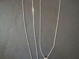 a couple of necklaces sitting on top of a table