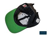 the hat is black and green with a white visor on it