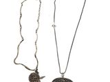 two necklaces with a pendant and a pendant with a bird on it