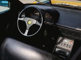 steering wheel and dashboard of a black sports car parked on the side of the road