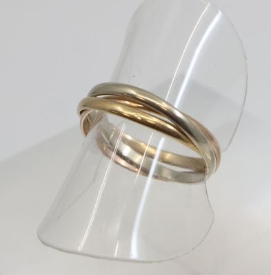 a close up of a gold ring on a clear ring holder