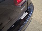a close up of a car ' s tail light with a sticker on it