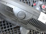 a fan that is sitting on top of a rack