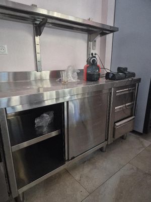 a large stainless steel kitchen with a sink and a stove