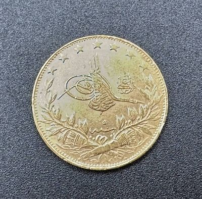 a close up of a gold coin with a bird on it