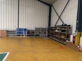 a room with a lot of shelves and a lot of bins