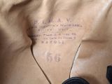someone is holding a black purse with a brown label on it