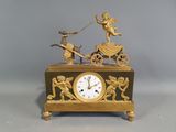 a clock that has a statue on top of it