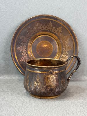 a cup and saucer sitting on a table