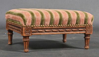 a small foot stool with a striped upholstered seat