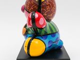 a close up of a colorful sculpture of a fish on a black base