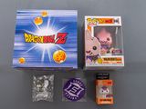 the dragon ball z box is open and it ' s next to some other items