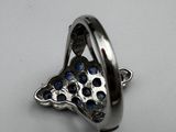 silver plated ring with blue stones in the middle of it