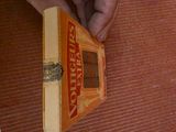 a hand that is holding a box of pizza
