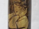 a vase with a picture of a woman on it