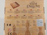 the travel chess set is in the box on the table