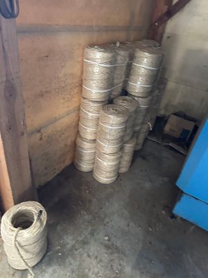 a stack of silver coils sitting in a room next to a blue refrigerator