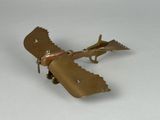un petit avion en métal posé sur une table