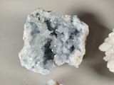 some white and blue crystals on a table with a piece of bread