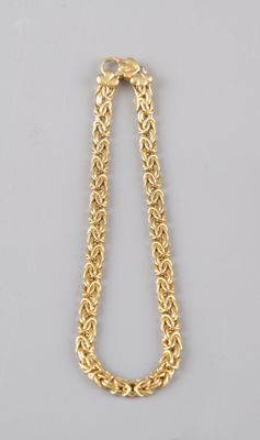 a gold chain necklace with a clasp on a white background