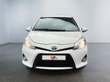 the front of a white toyota yaris parked in a white room