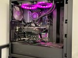 a black computer case with purple lights on top of a table