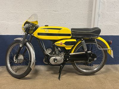 a yellow and black motorcycle parked in a garage