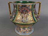 a gold and green vase with a mosaic design on it