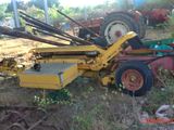 a tractor that is sitting in the grass near a tractor