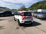 cars parked in a parking lot with a red and white stripe on the back of the car