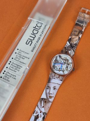 a watch with a picture of a woman on it next to a plastic case