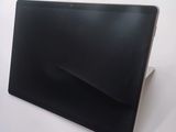 a black tablet computer sitting on a white surface