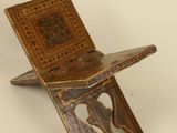 a small wooden chair that is sitting on a table
