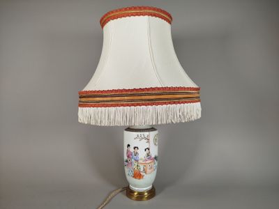 a lamp that is sitting on a table with a lamp shade on it