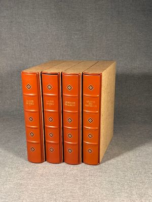three books are stacked on top of each other on a gray surface