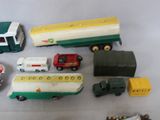 a lot of toy cars and trucks that are on the table