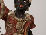 a figurine of a woman holding a mirror in her hand
