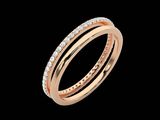 a rose gold ring with diamonds on a black background