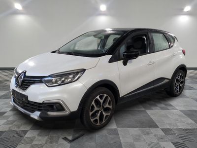 a white car is parked in a room with a checkered floor