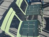 many chairs lined up in a row on the pavement