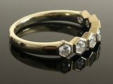 an image of a diamond ring on a black surface